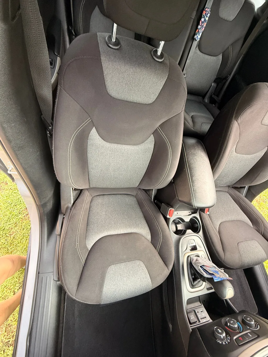 Driver seat of the silver Jeep Cherokee after an interior detail, cloth cleaned and the floor beside it vacuumed