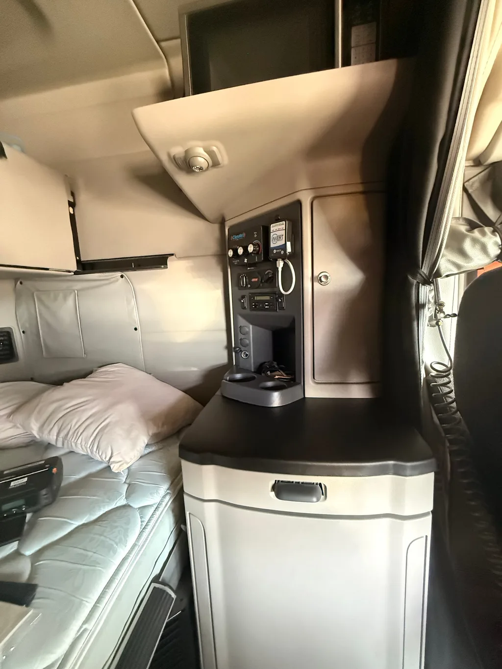 Sleeper cabinet and refrigerator in the semi truck after an interior detail, counter top and fridge door wiped clean