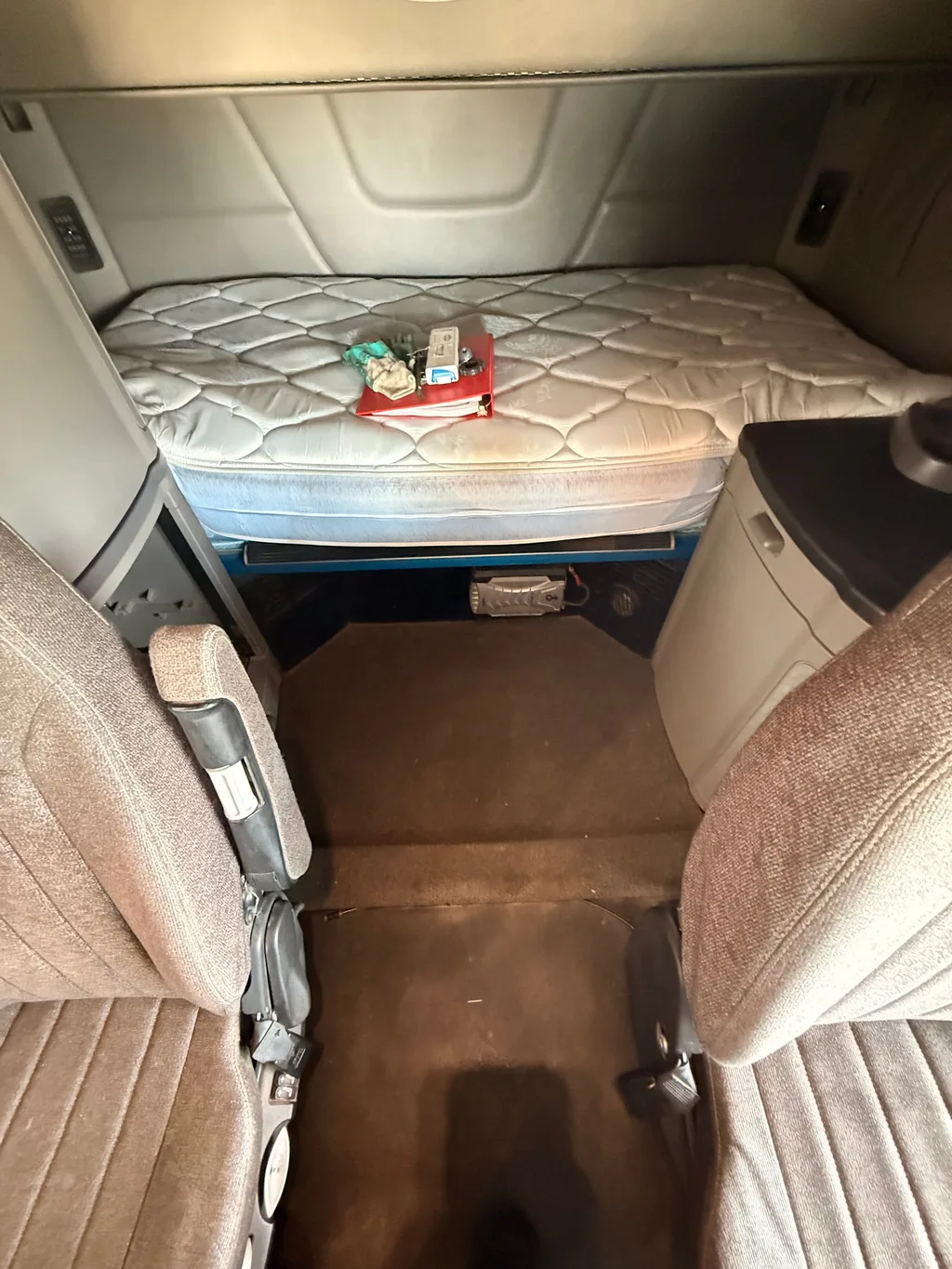 Semi truck sleeper after an interior detail, floor between the seats vacuumed clean and the mattress in place